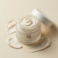 Angle : Vue plongeante à 30°  Open Beauty of Joseon Dynasty Cream jar with smooth cream swirl visible, placed on creamy beige background with artistic cream smears around it, luxury skincare editorial photography, soft natural lighting, realistic product texture, premium beauty advertising, macro details, high-end cosmetic campaign. (gemini-3.1-flash-image-preview)