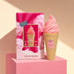 Bold, contemporary e-commerce product shot of the Arabiyat Sugar Cotton Blush perfume bottle and box (image_b1ef0b.jpg). The products are displayed on a matte pastel pink geometric pedestal against a clean, contrasting light beige backdrop. High-contrast, sharp architectural shadows cut elegantly across the frame, simulating a modern candy shop or trendy boutique lighting. Fresh, youthful, and eye-catching layout. Aspect ratio 1:1, size 1200x1200px. (gpt-image-2)